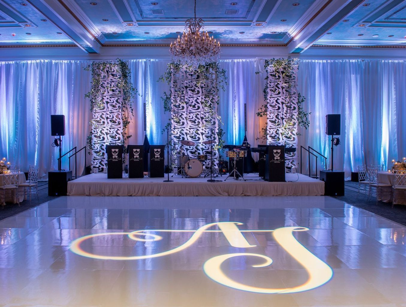 A large ballroom with a dance floor and a stage.