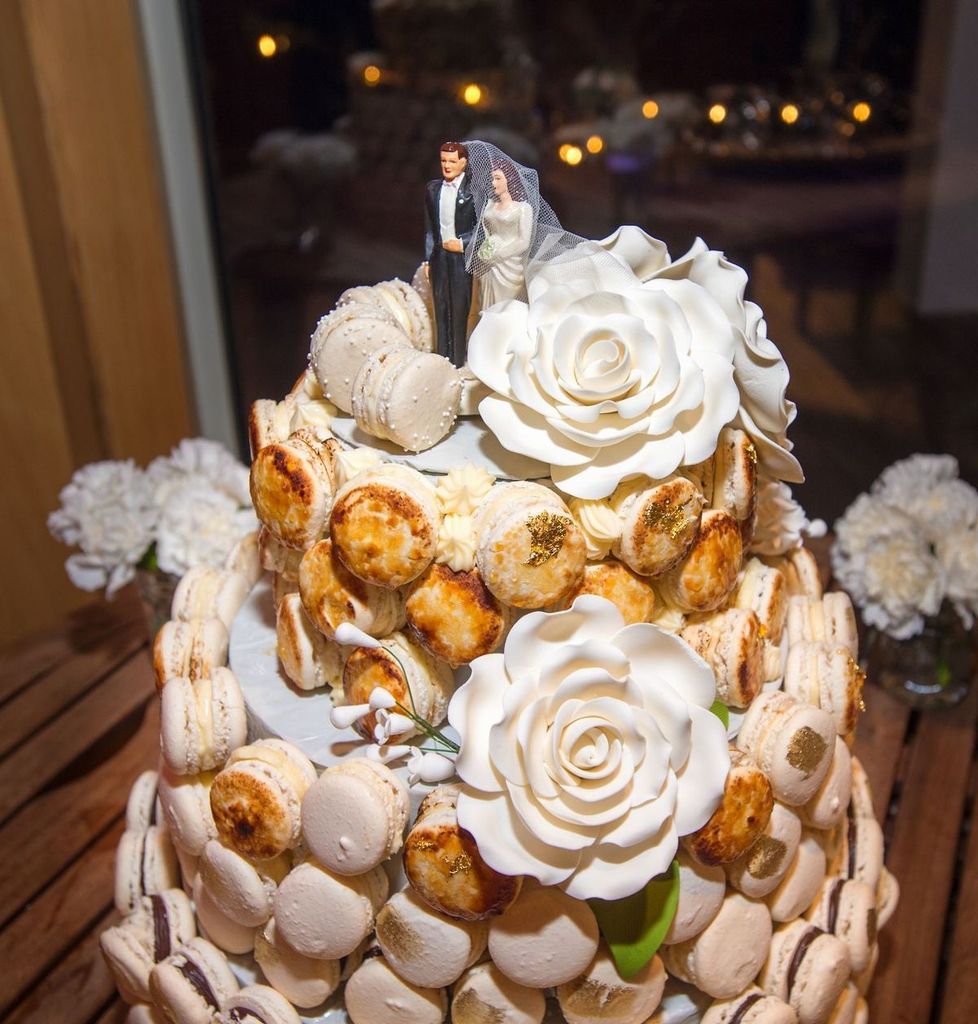 A wedding cake with a bride and groom figurine on top