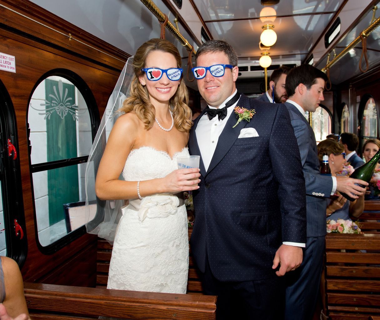 A bride and groom are posing for a picture on a bus