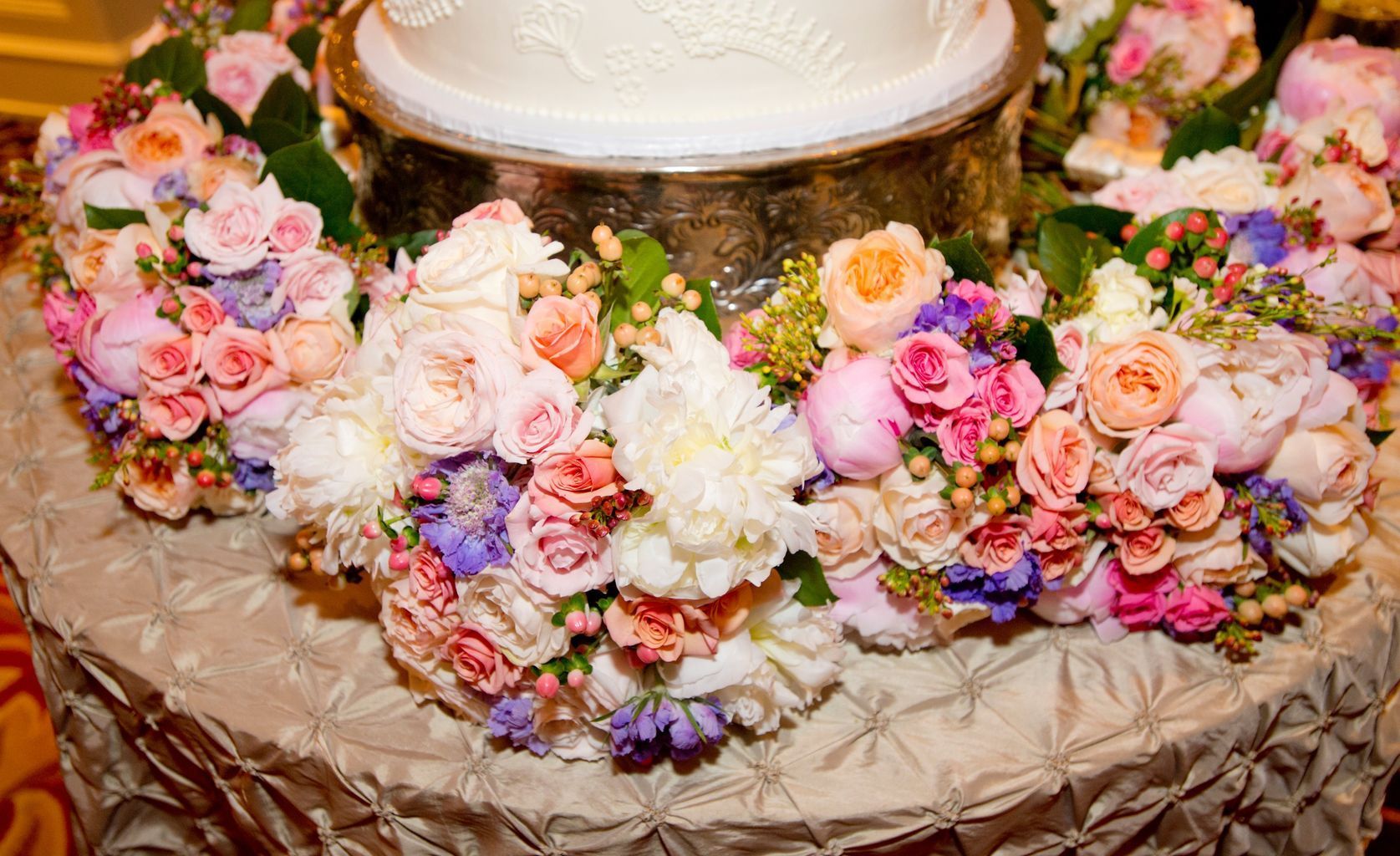 A large room filled with tables and chairs and a chandelier.