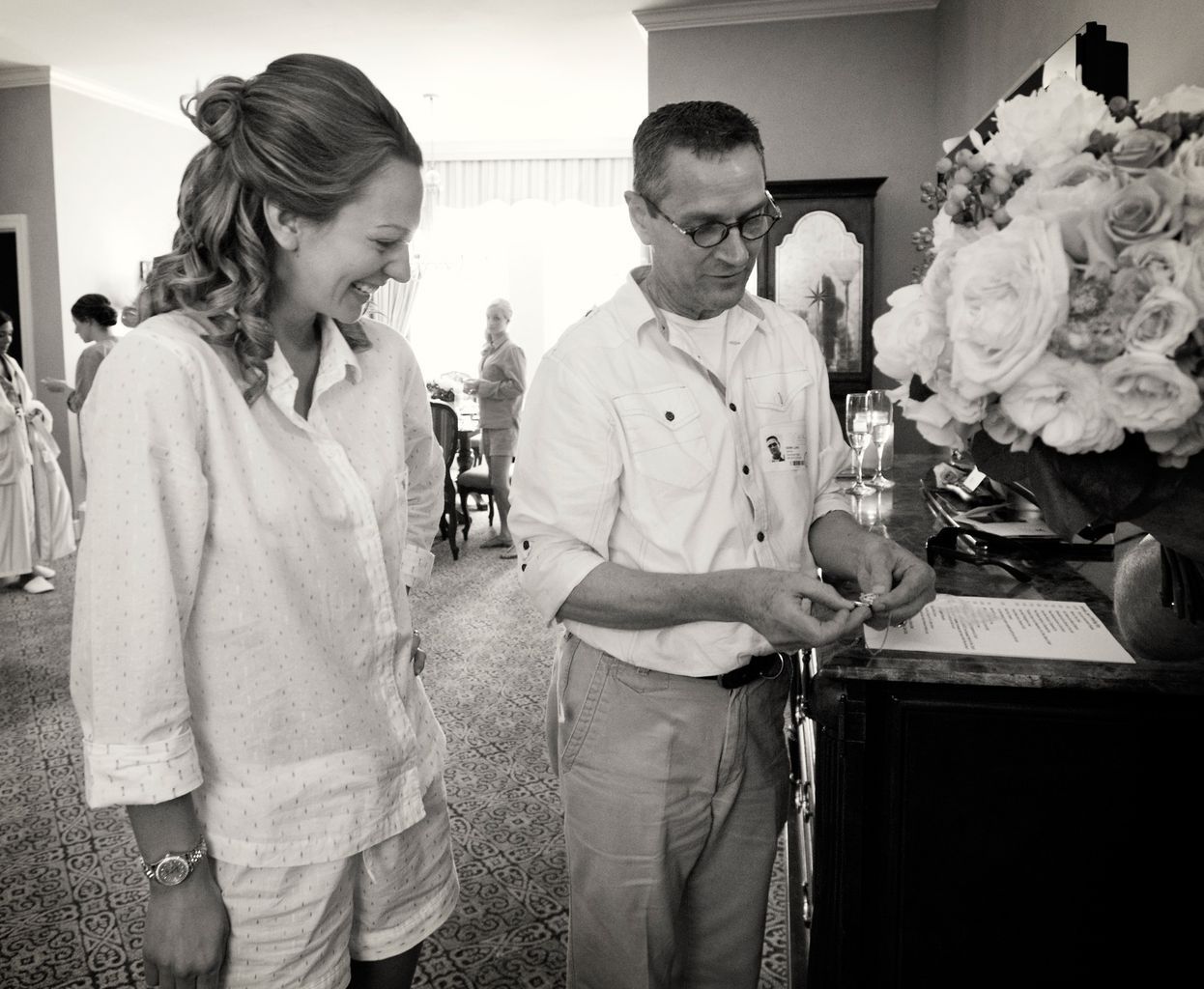A man and a woman are standing next to each other in front of a piano.
