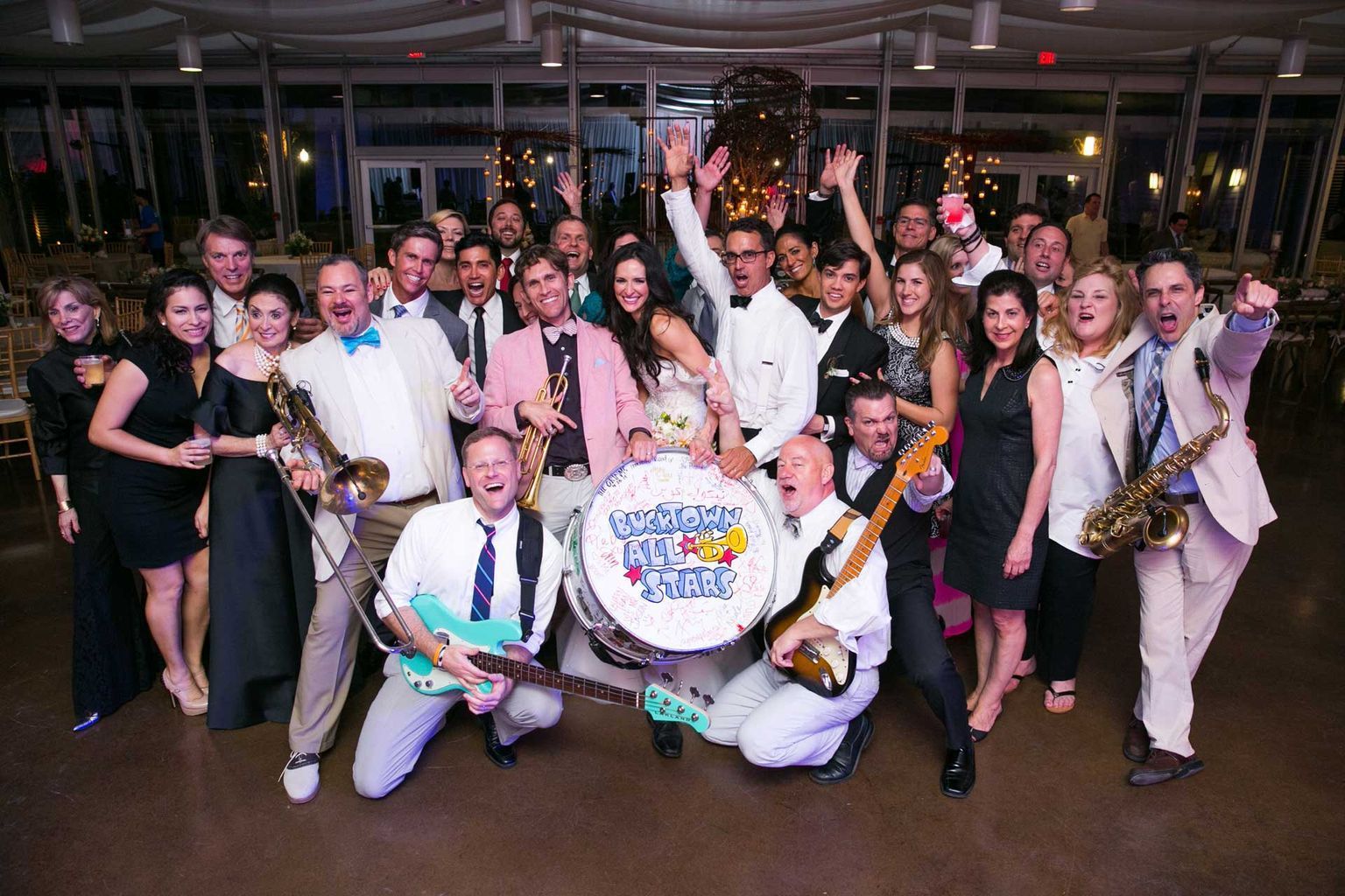 A large group of people are posing for a picture with their instruments.