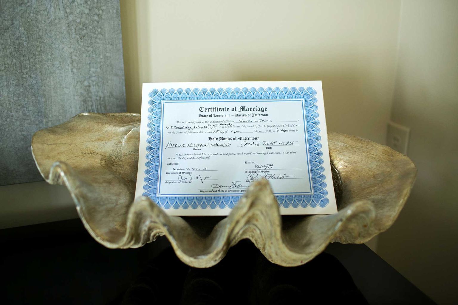 A certificate is sitting on top of an oyster shell