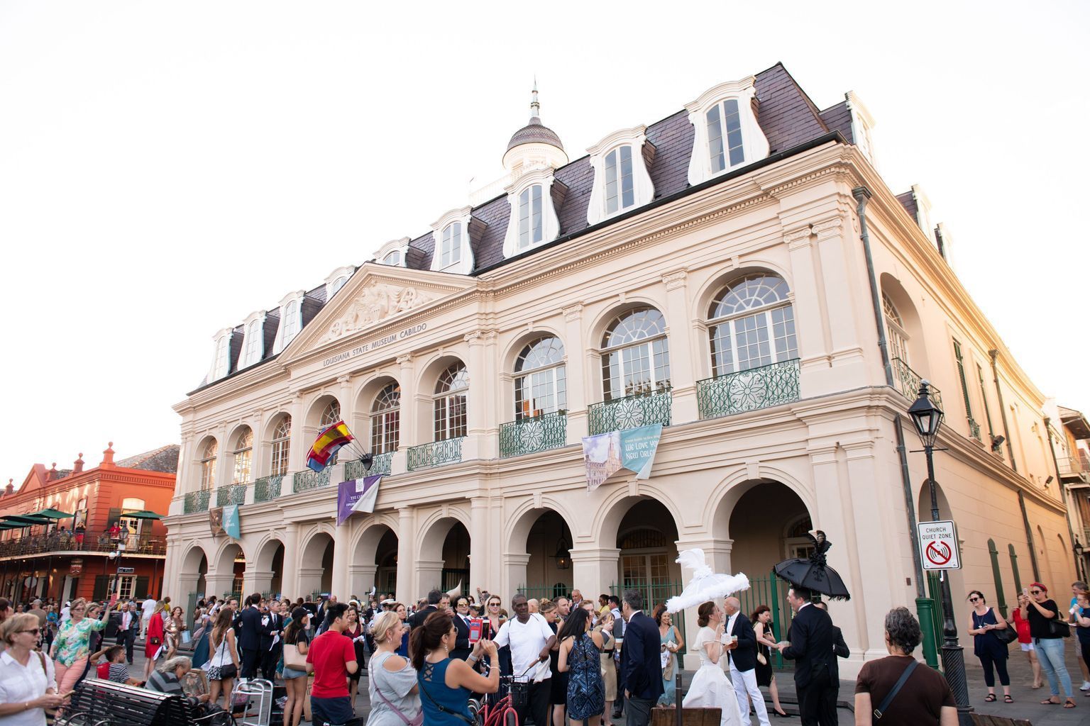 A group of people are standing in front of a large building.