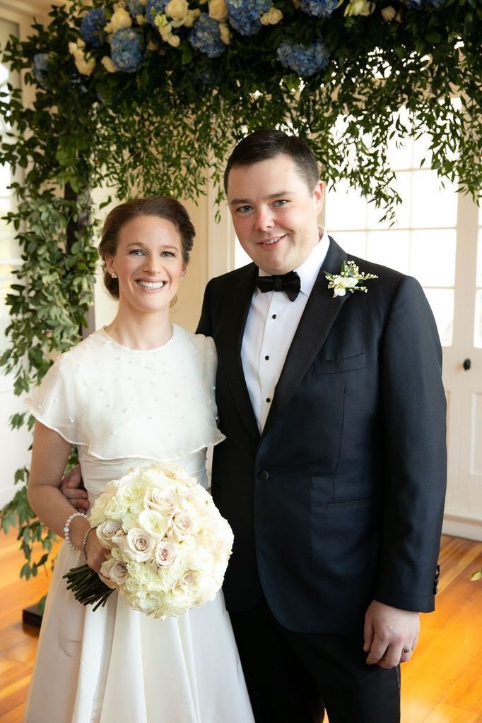 A bride and groom are posing for a picture on their wedding day.