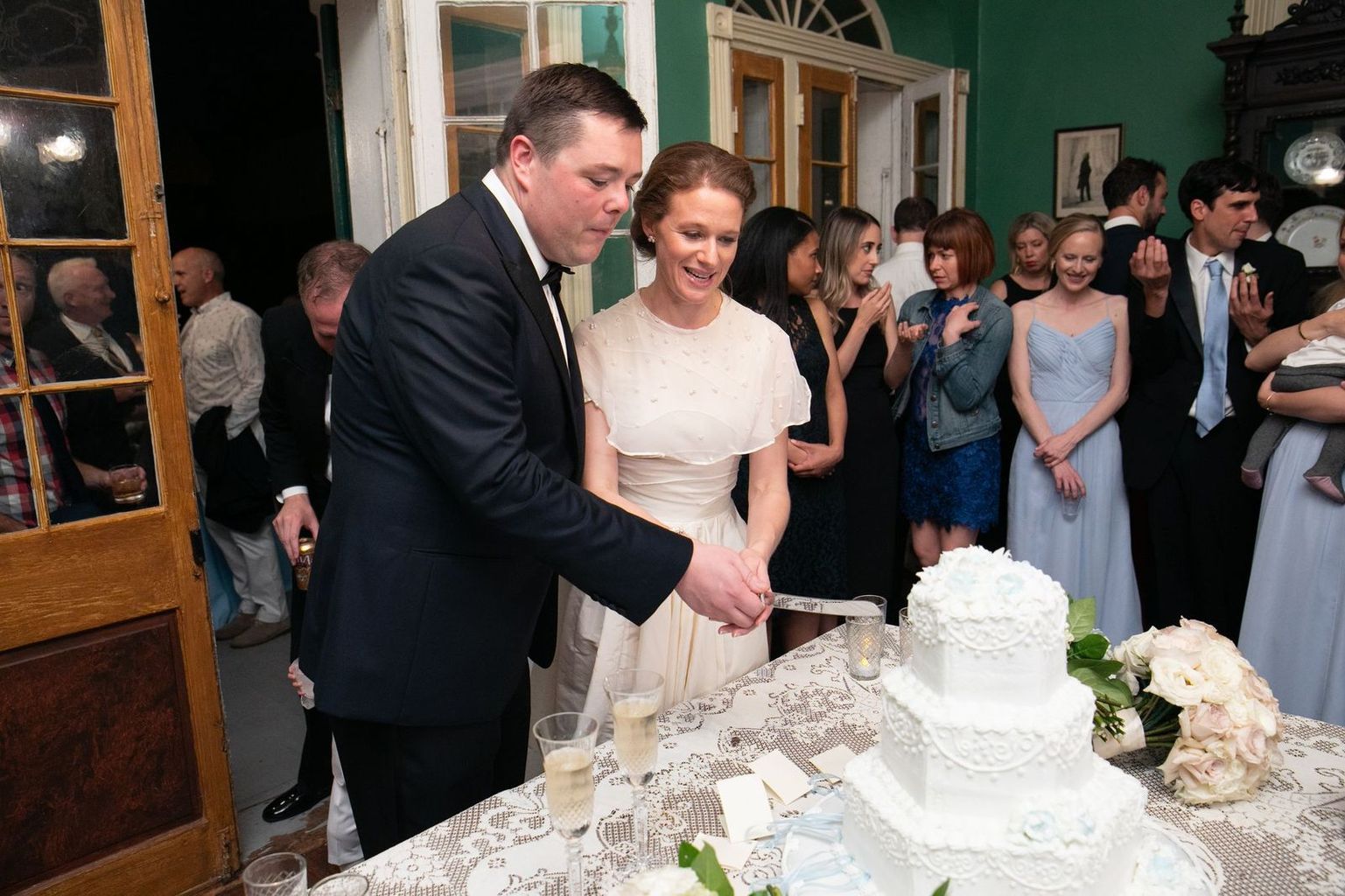 A bride and groom are cutting their wedding cake