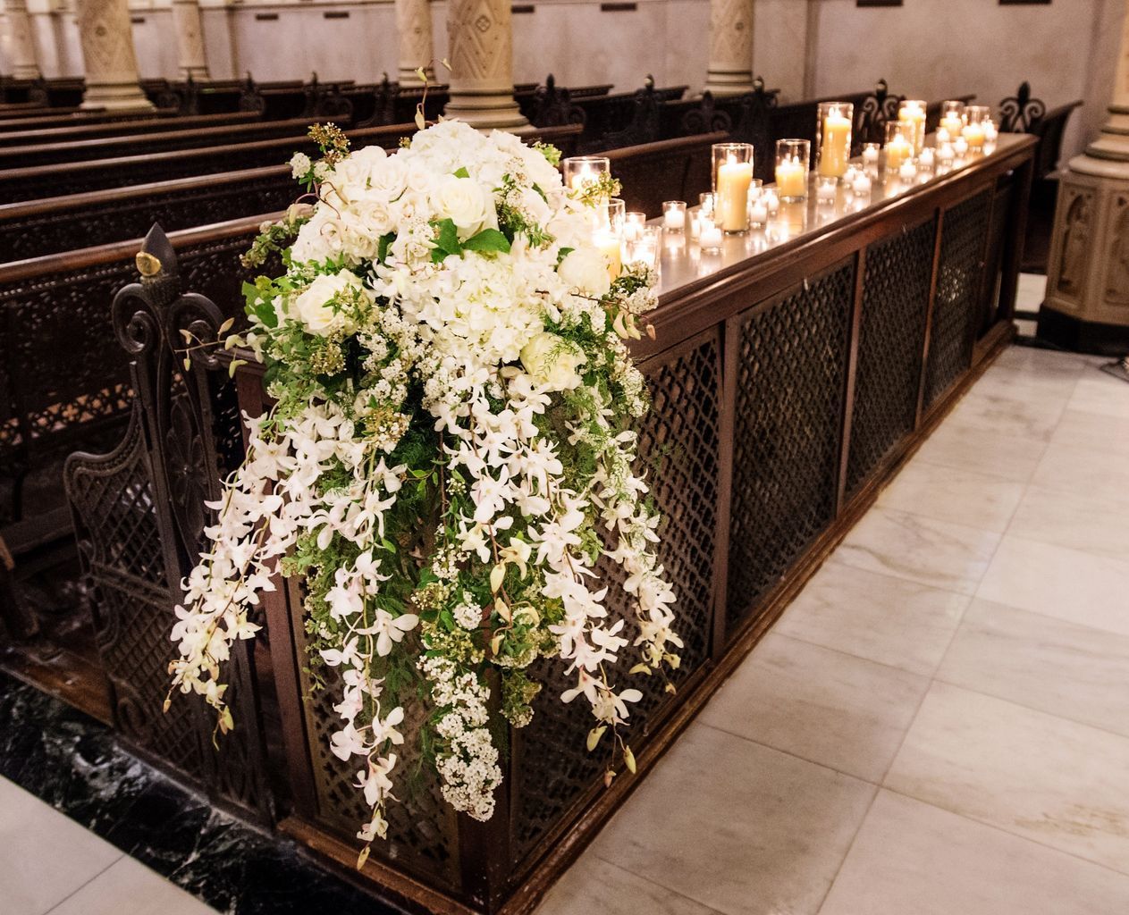 A church with candles and flowers on the pews