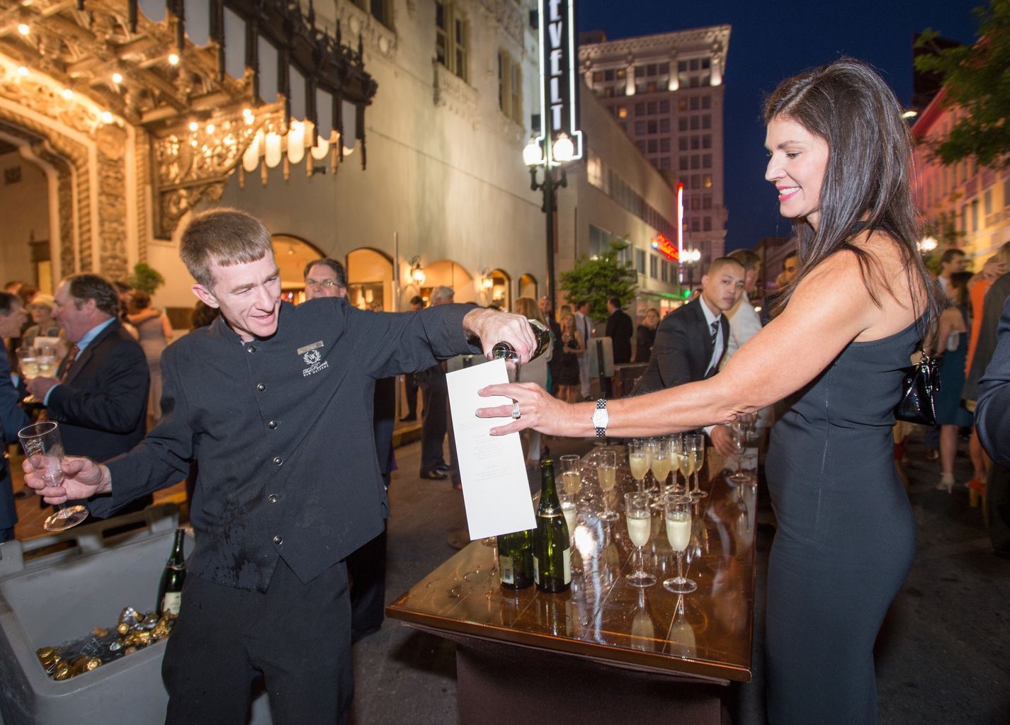 A man is pouring champagne into a woman 's glass.