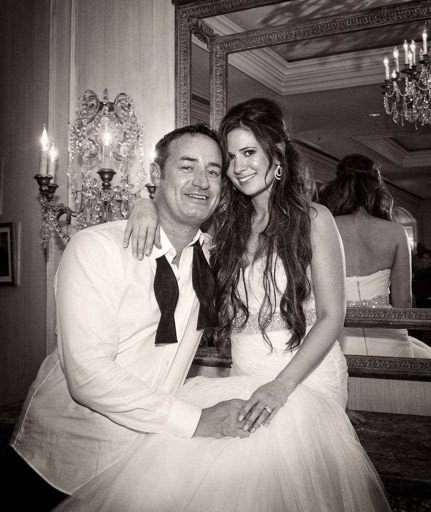 A black and white photo of a bride and groom posing for a picture.
