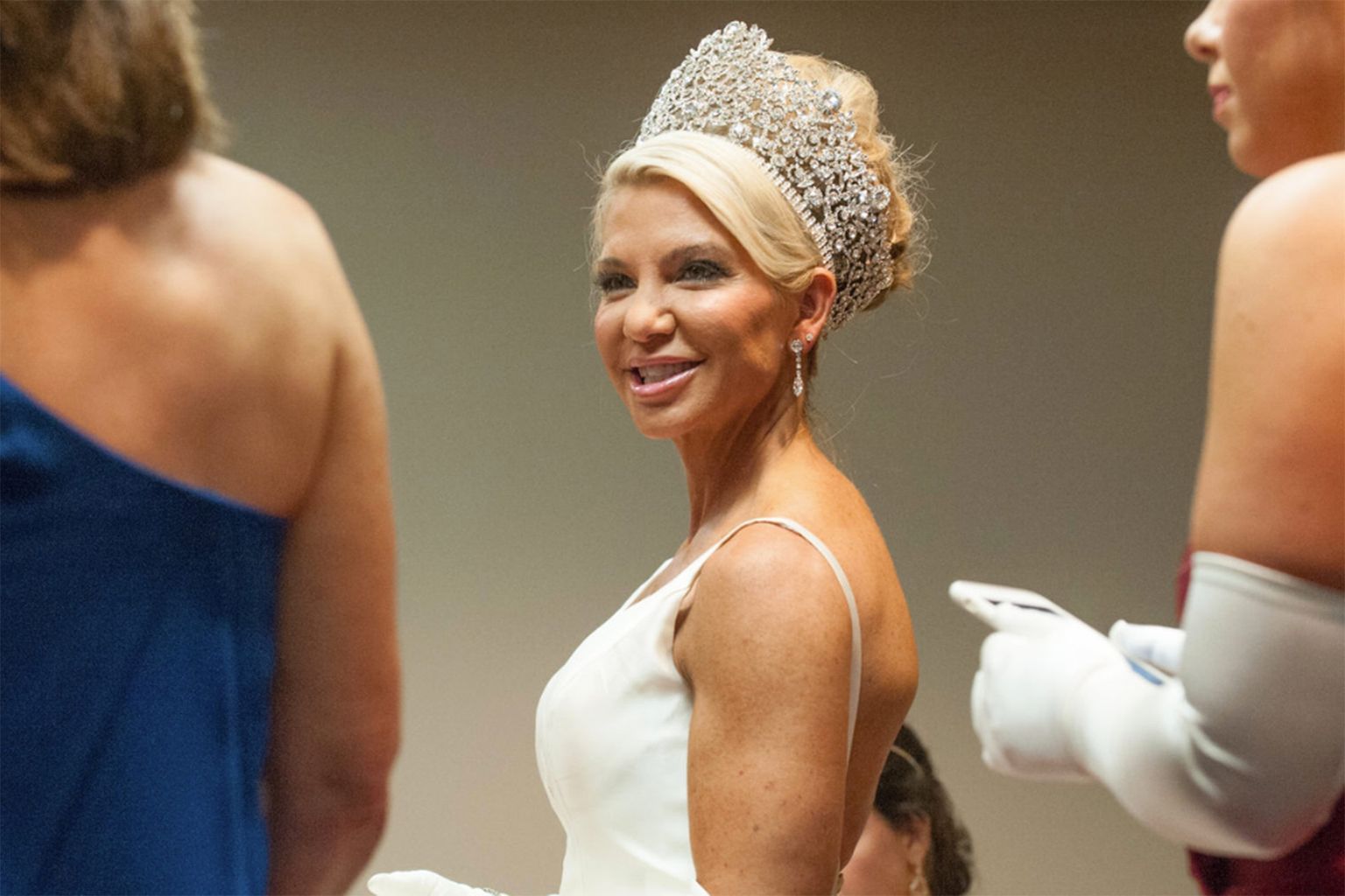 A woman in a white dress with a tiara on her head