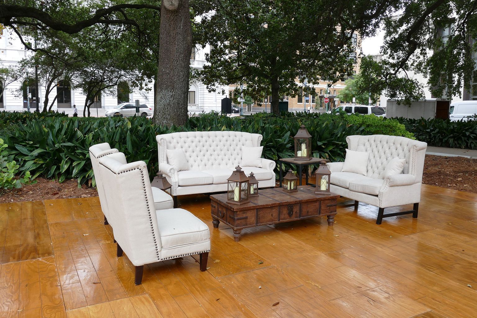 A wooden floor with a couch and chairs on it