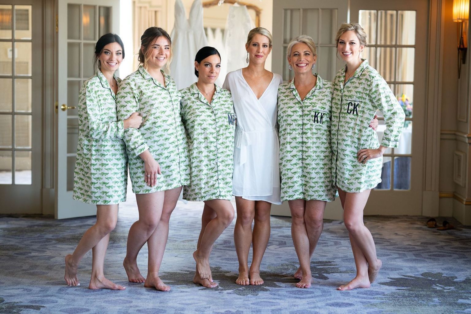 A bride and her bridesmaids are posing for a picture in their pajamas.