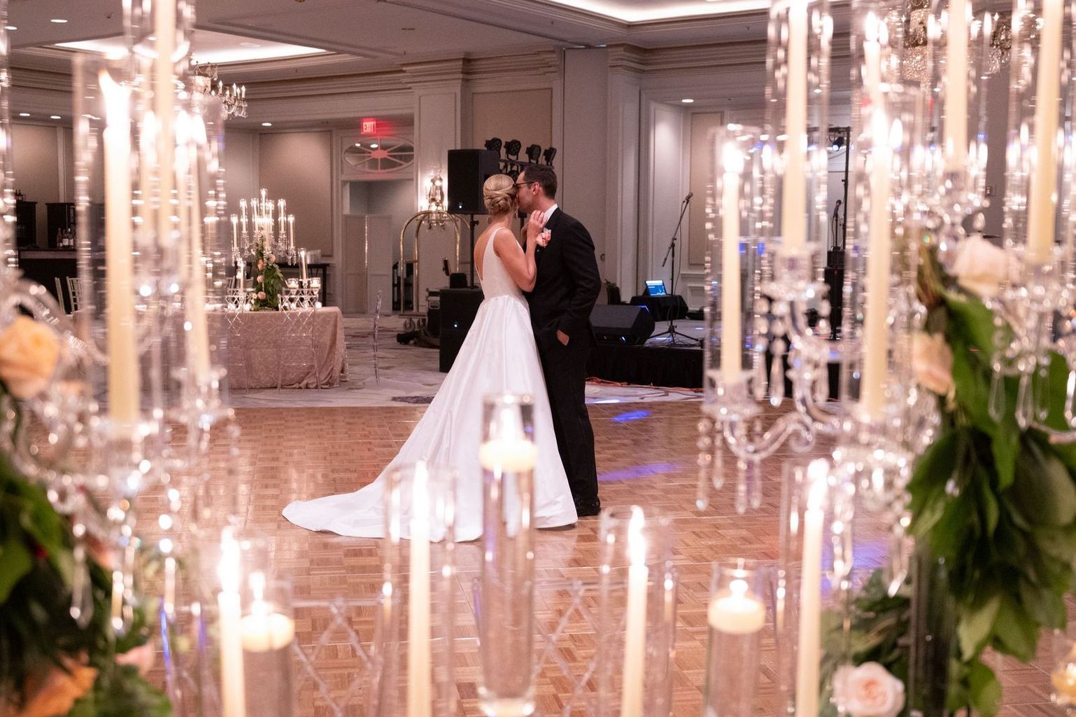 A large room filled with tables and chairs and a chandelier.