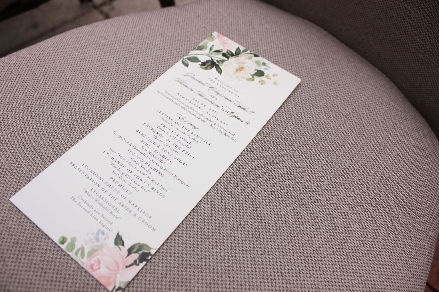 A wedding program is sitting on a chair.