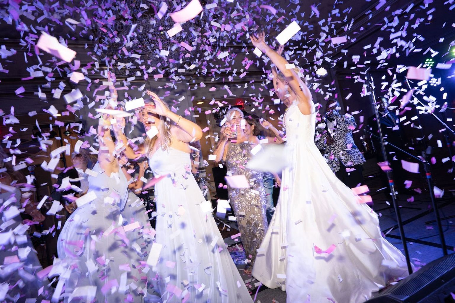 A large room filled with tables and chairs and a chandelier.