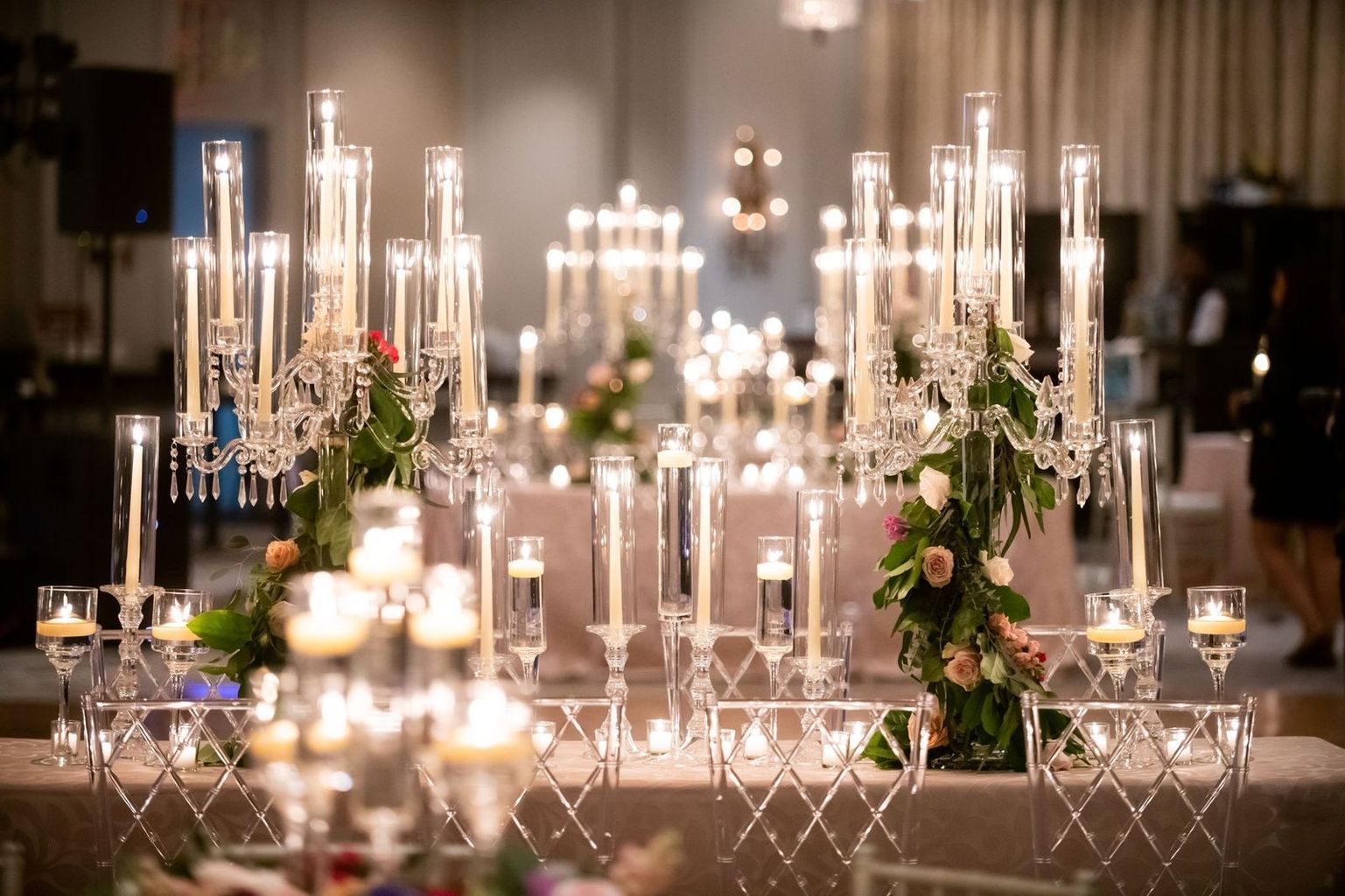 A large room filled with tables and chairs and a chandelier.