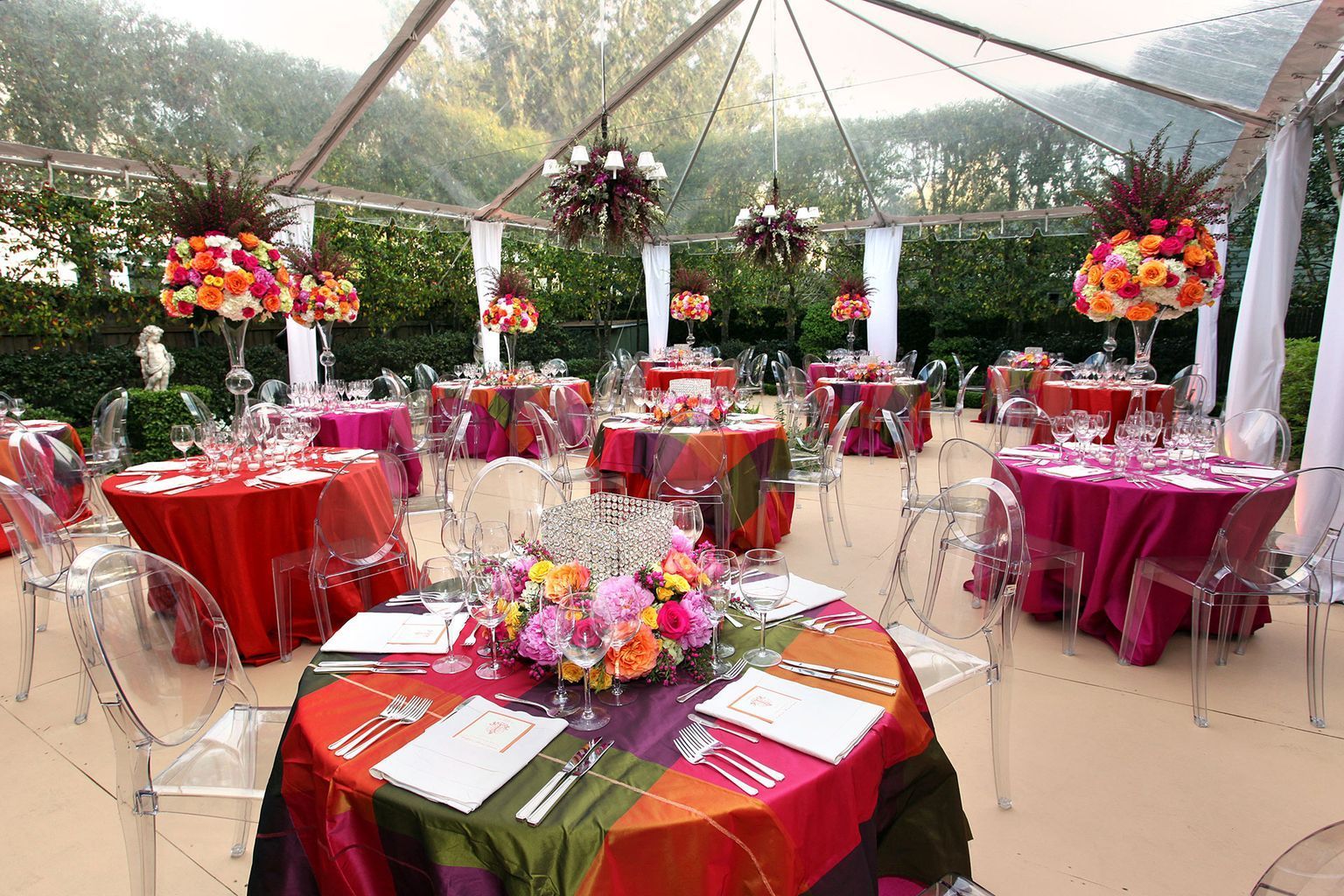 A large room filled with tables and chairs and a chandelier.