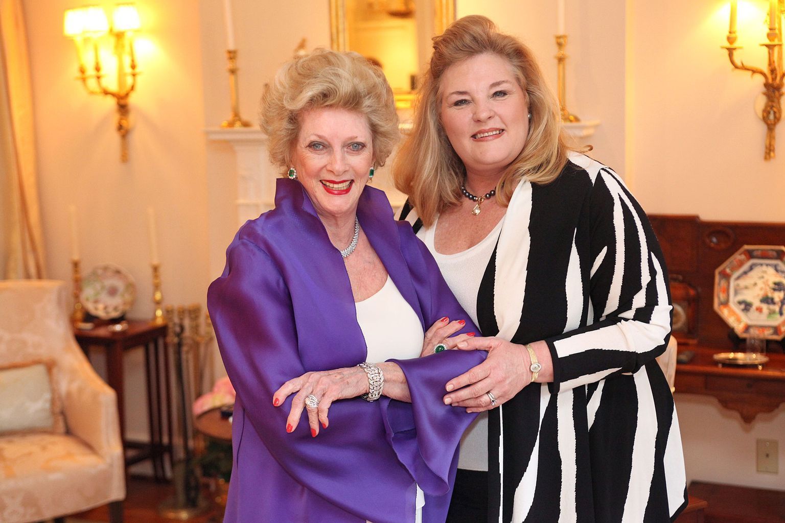 Two women standing next to each other in a living room