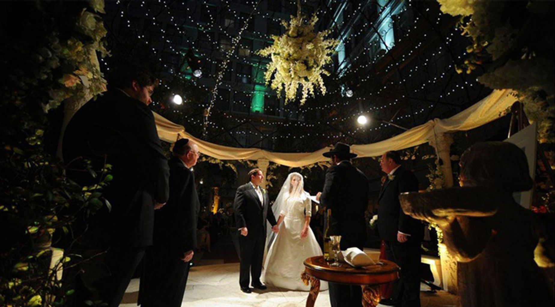 A large room filled with tables and chairs and a chandelier.