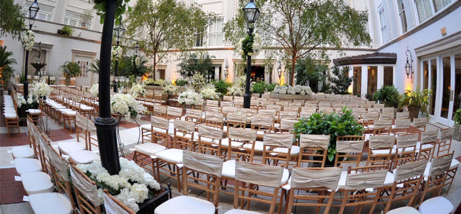 A large room filled with tables and chairs and a chandelier.