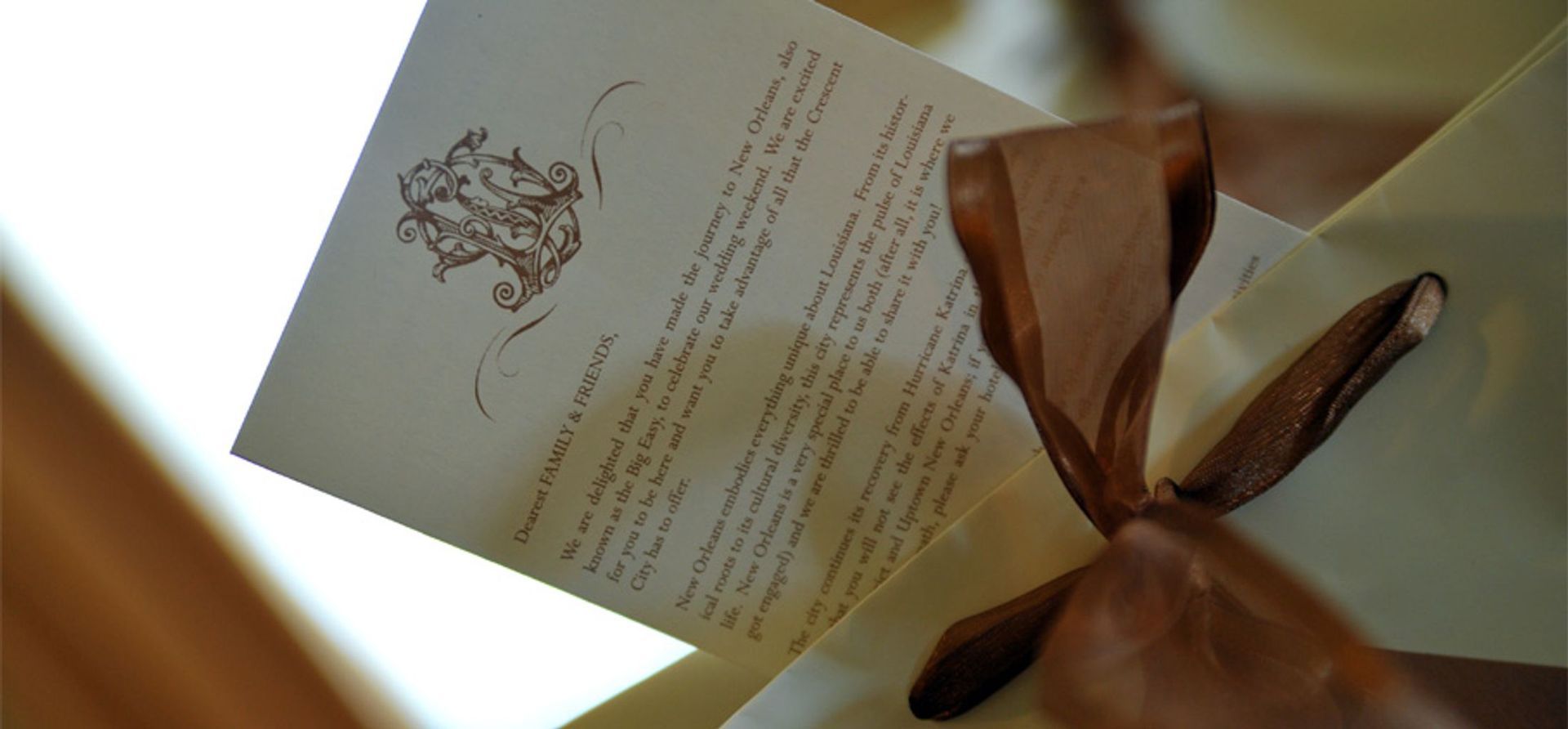 A piece of paper with a brown ribbon tied around it
