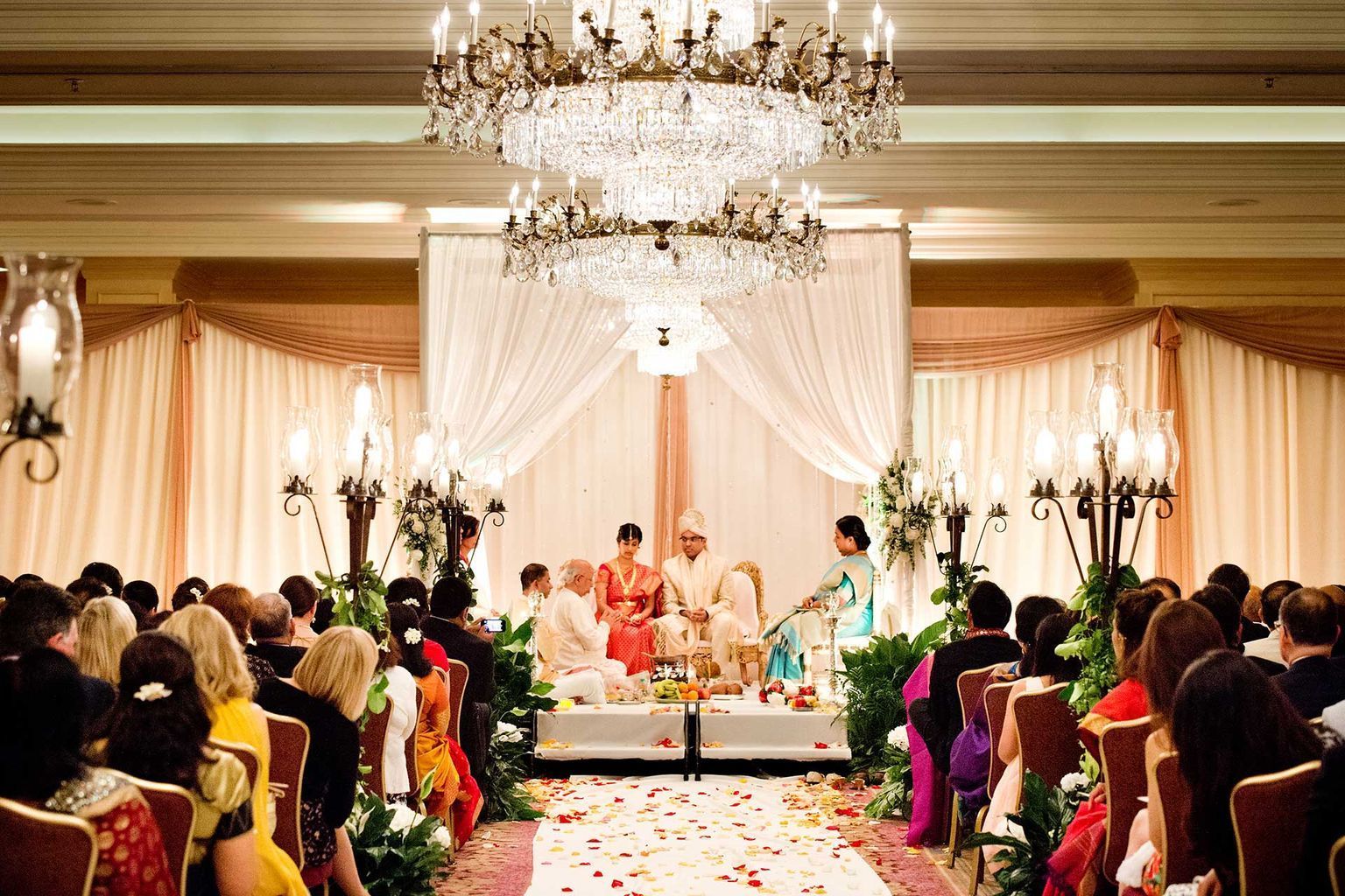A group of people are sitting in a room at a wedding ceremony.