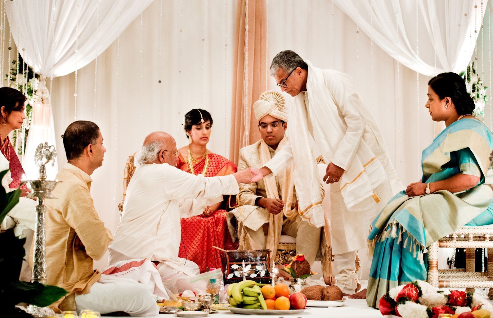 A group of people are sitting around a table at a wedding ceremony.