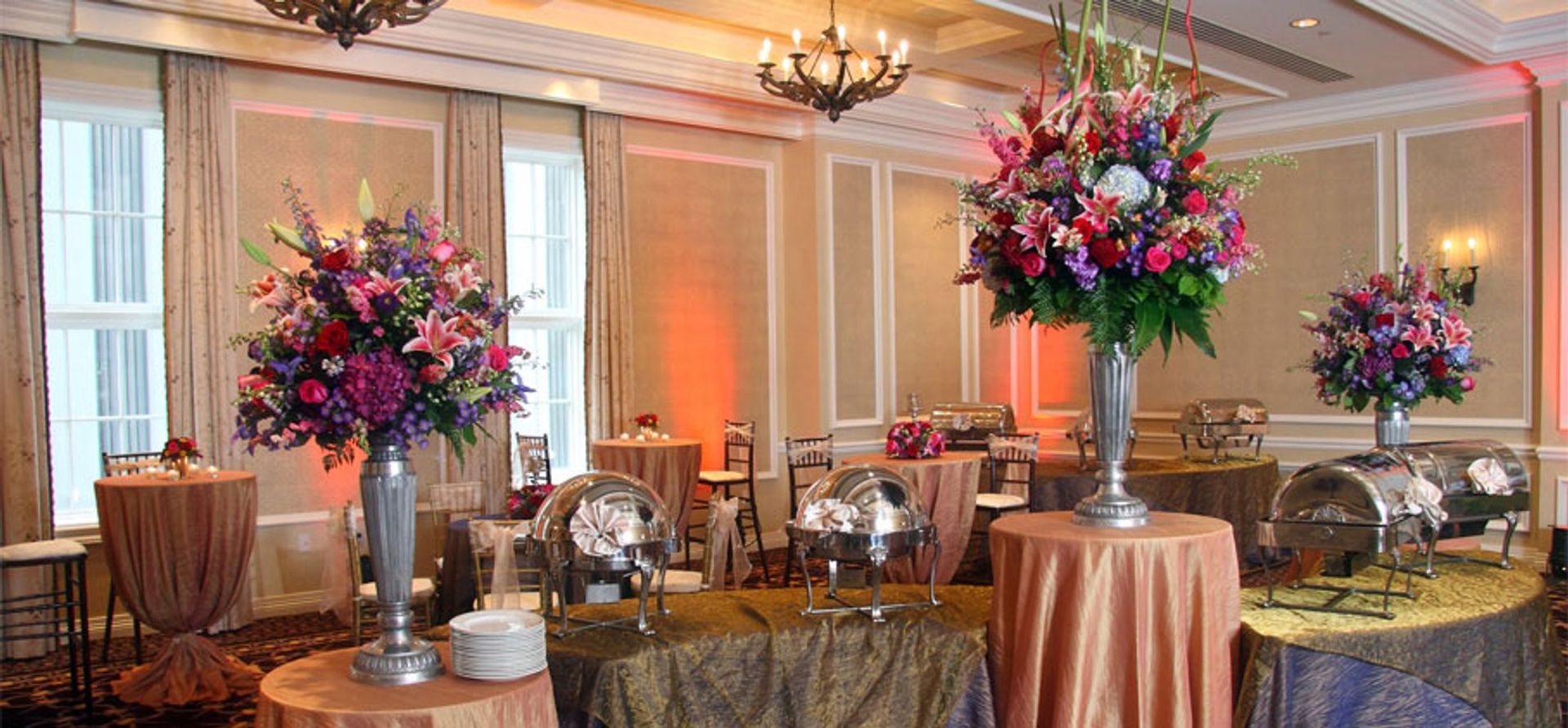 A room filled with tables and vases of flowers.