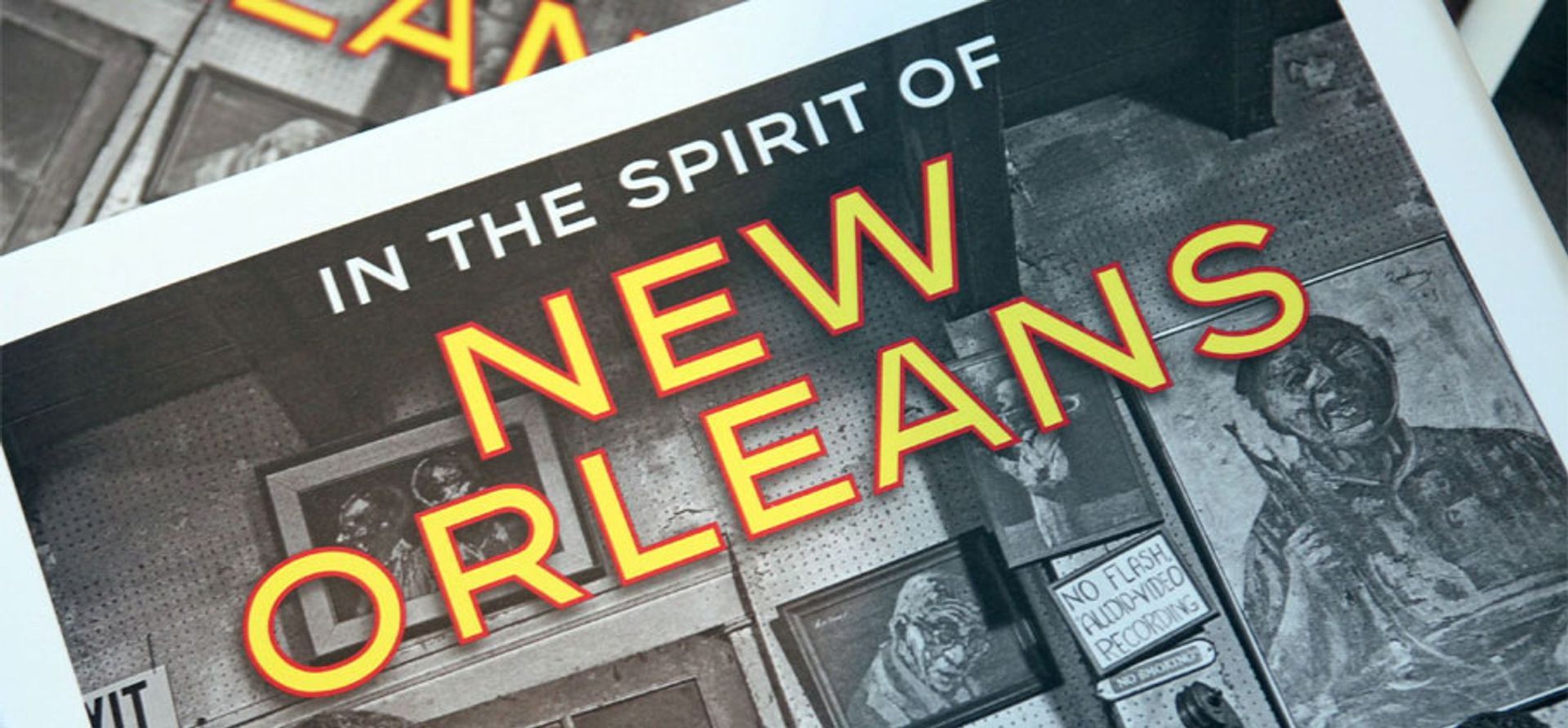 A book titled in the spirit of new orleans is sitting on a table.