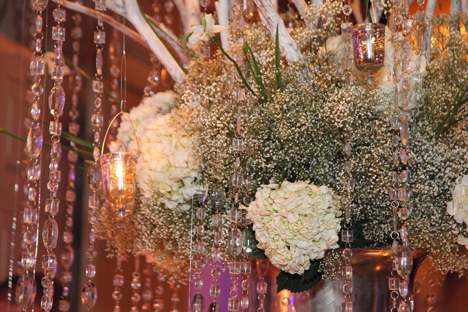 A vase filled with white flowers on a table.