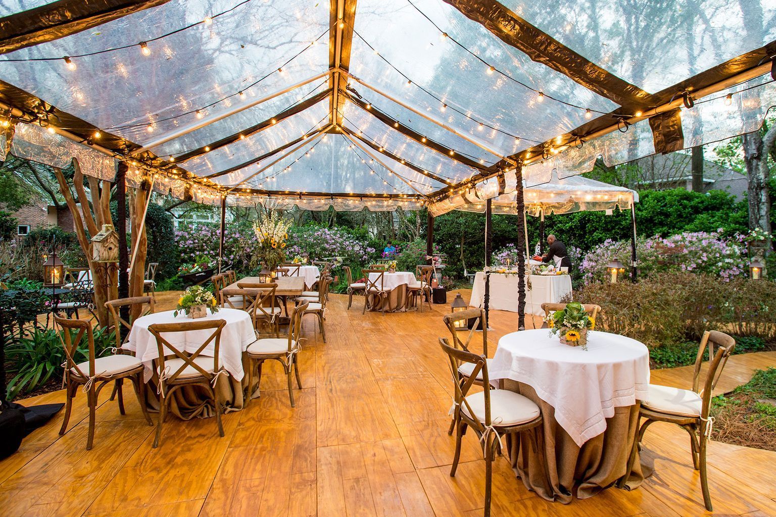 A large room filled with tables and chairs and a chandelier.