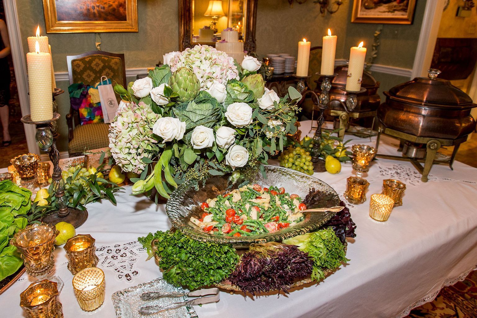 A table with a bunch of food and candles on it