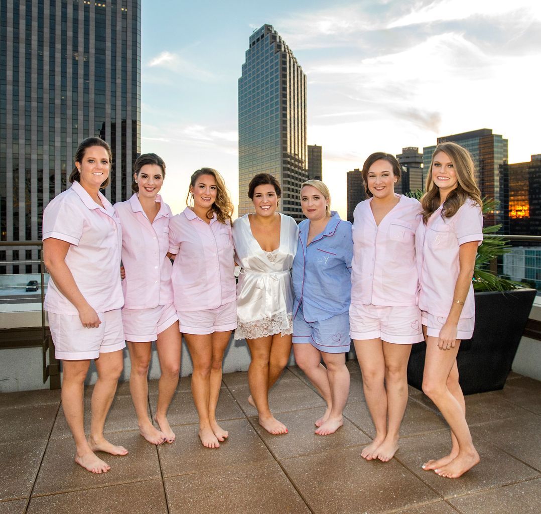 A group of women posing for a picture on a rooftop