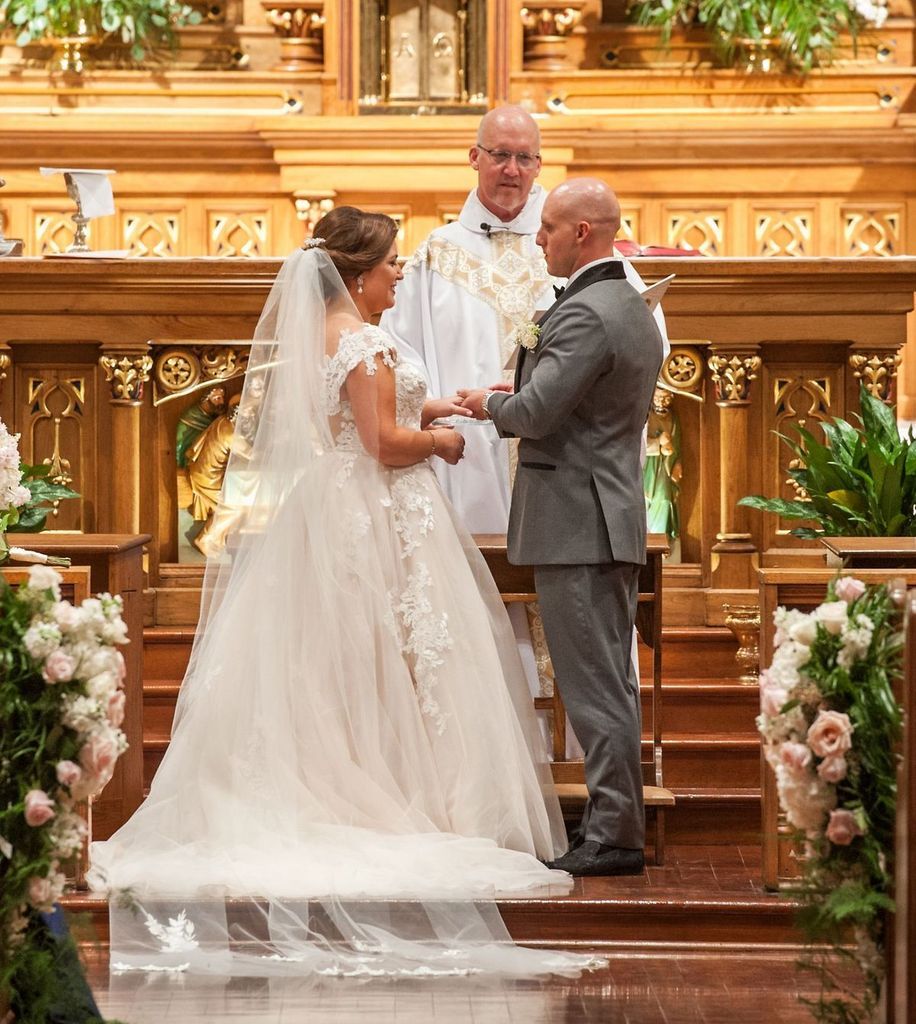 A bride and groom are getting married in a church