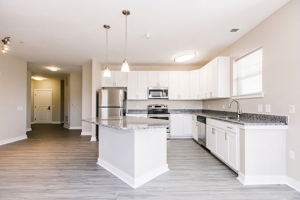 Bathroom with vanity, toilet, towel rack, mirror, and shower curtain in neutral beige tones