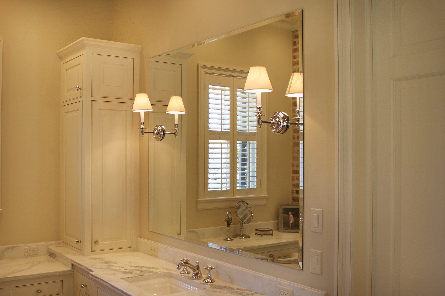 A bathroom with two sinks and a large mirror.