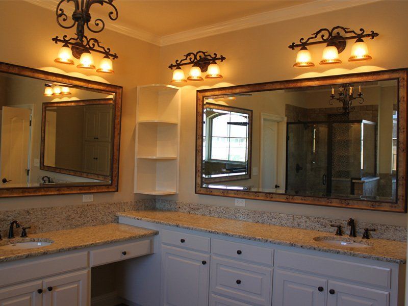 A bathroom with two sinks and two mirrors