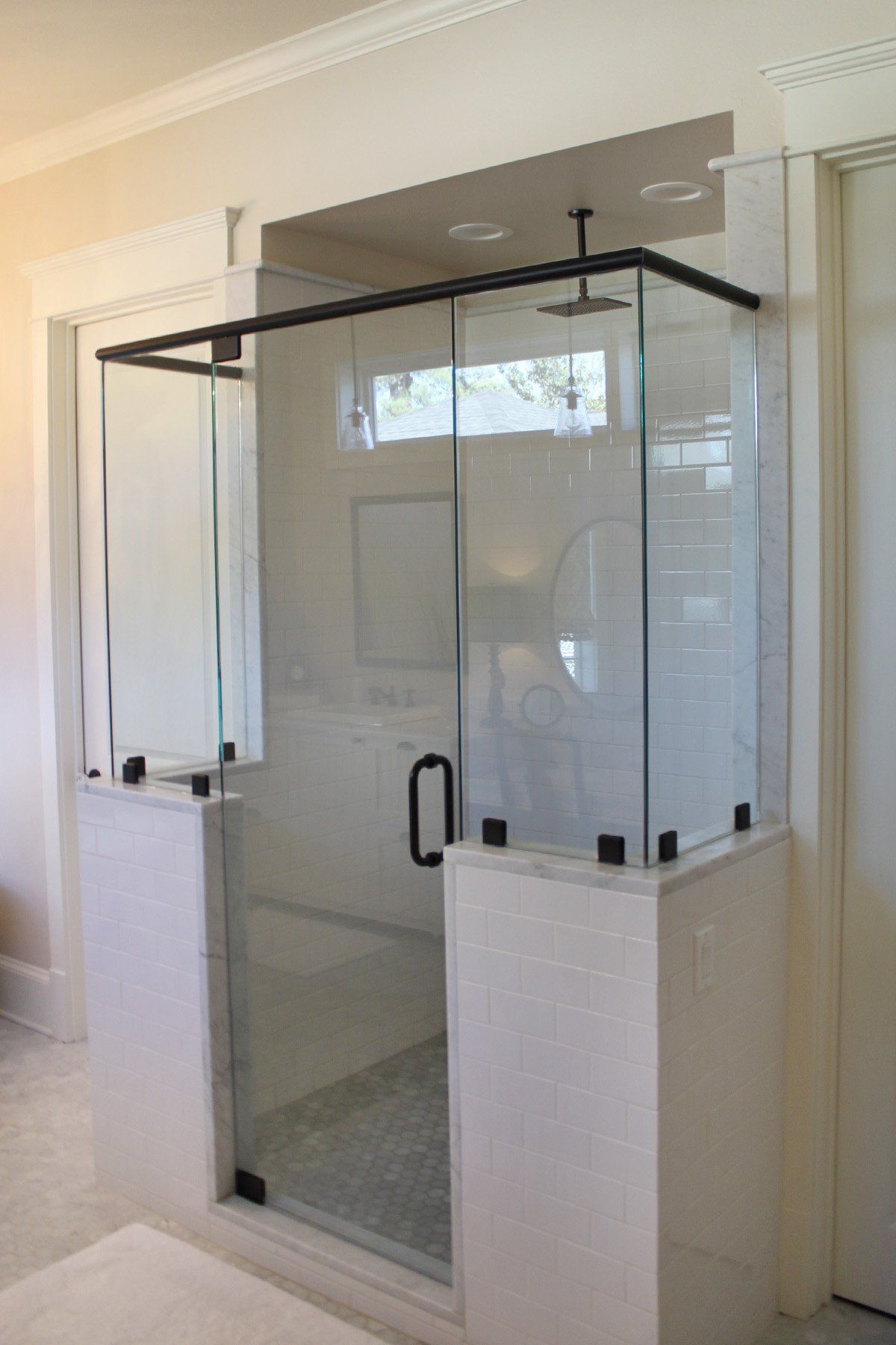 A bathroom with a sliding glass shower door.