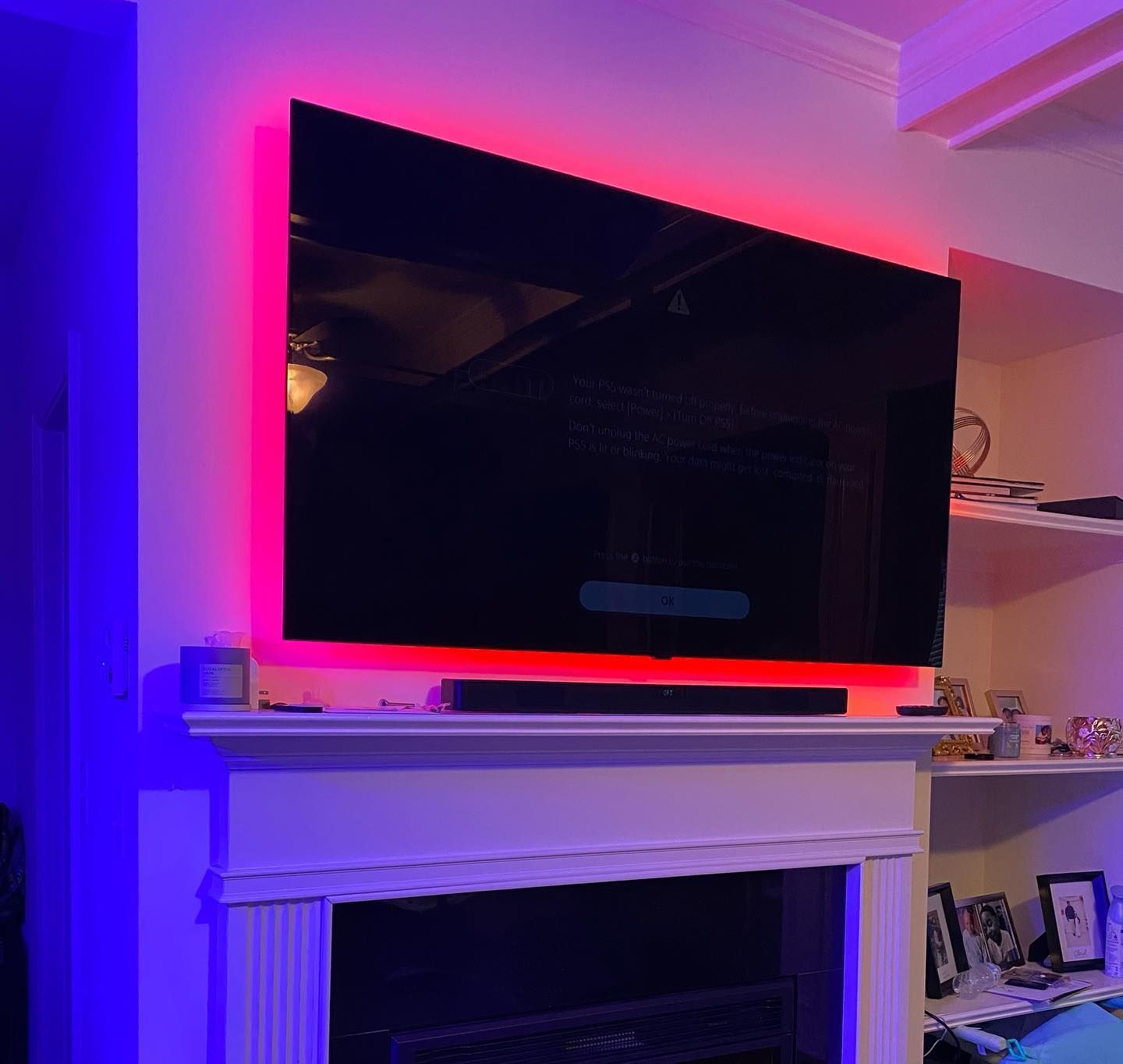 3Cs Audio-Visuals LLC | TV mounting above fireplace with red and blue LED backlighting in Atlanta living room