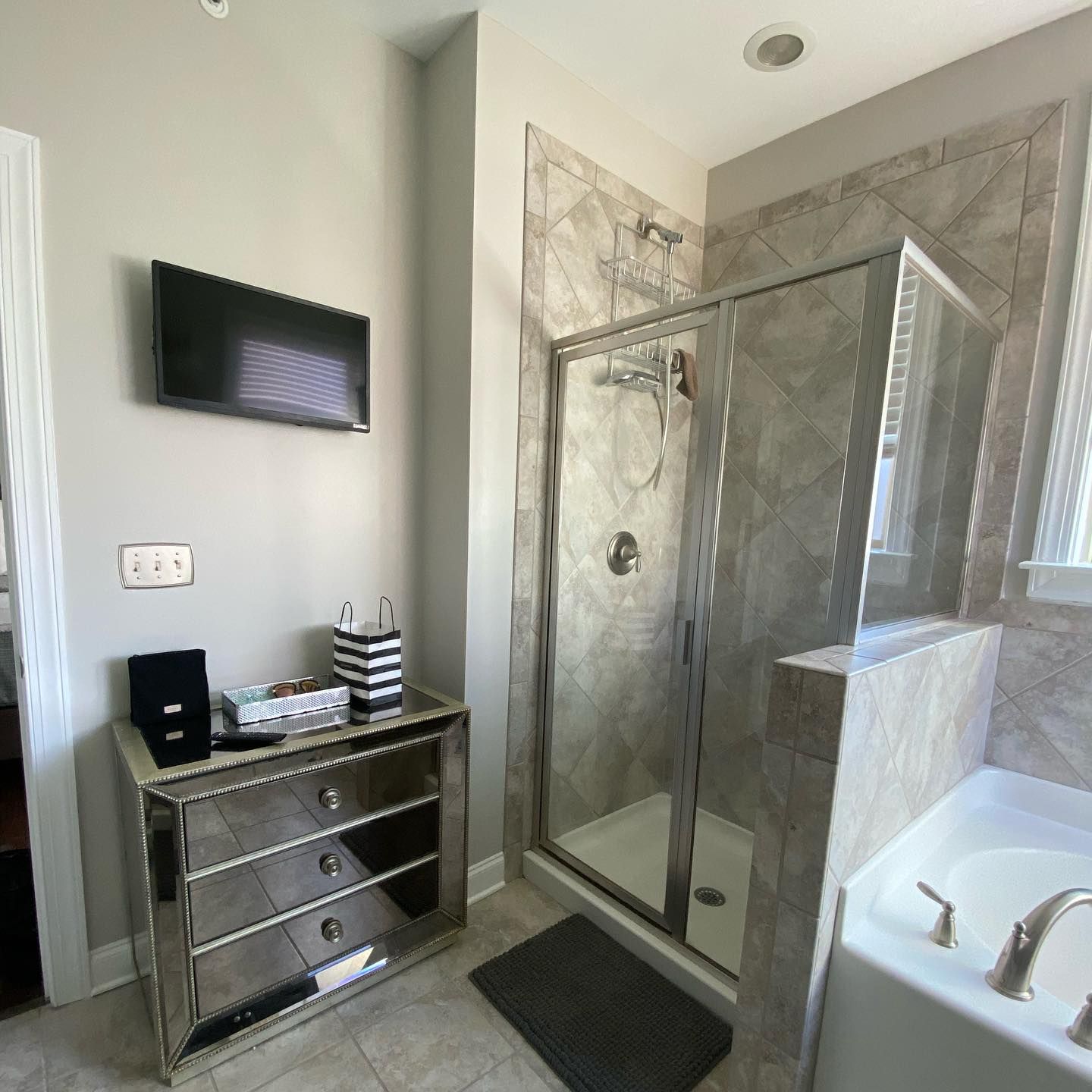 3Cs Audio-Visuals LLC | Small wall-mounted TV setup in bathroom using home tv mounting service with cable management