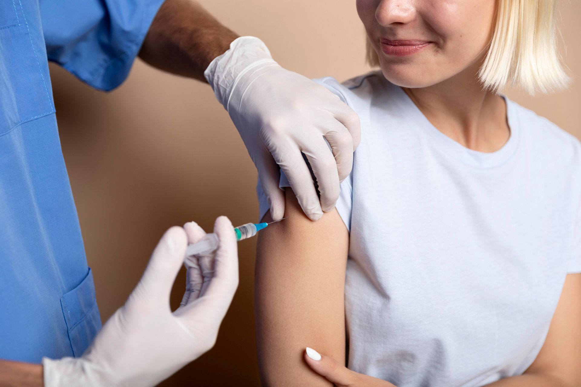 A woman is getting an injection in her arm.