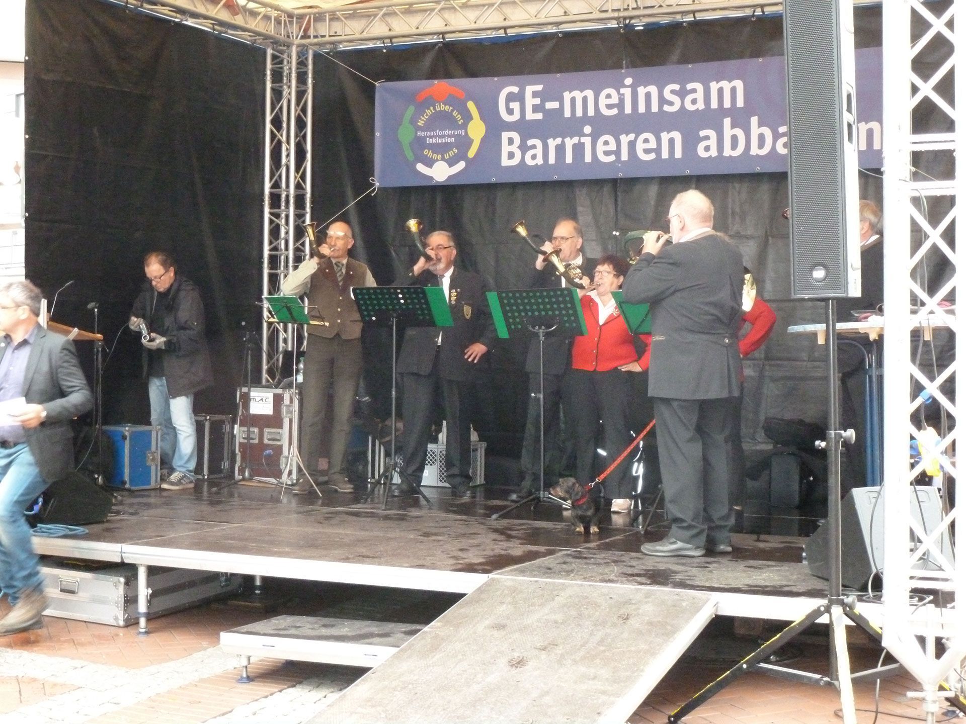 Eine Gesangsgruppe vorwiegend älterer Herren auf einer Bühne.