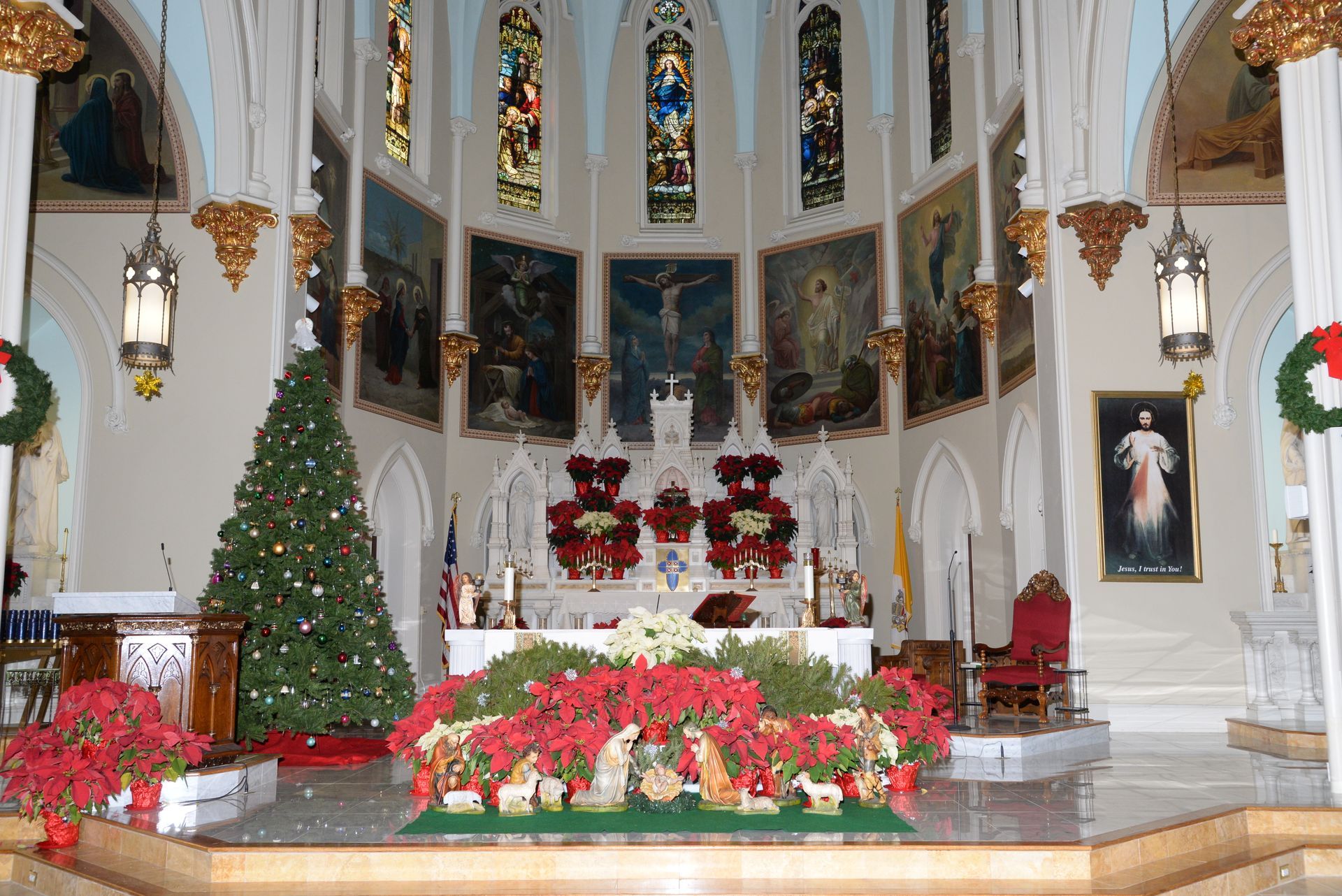 The inside of a church decorated for christmas with a christmas tree