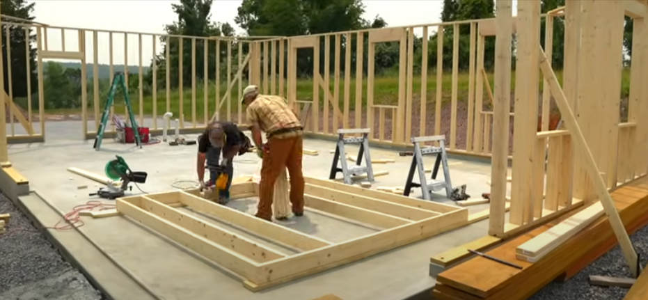 Construction workers framing up the walls for a new garage