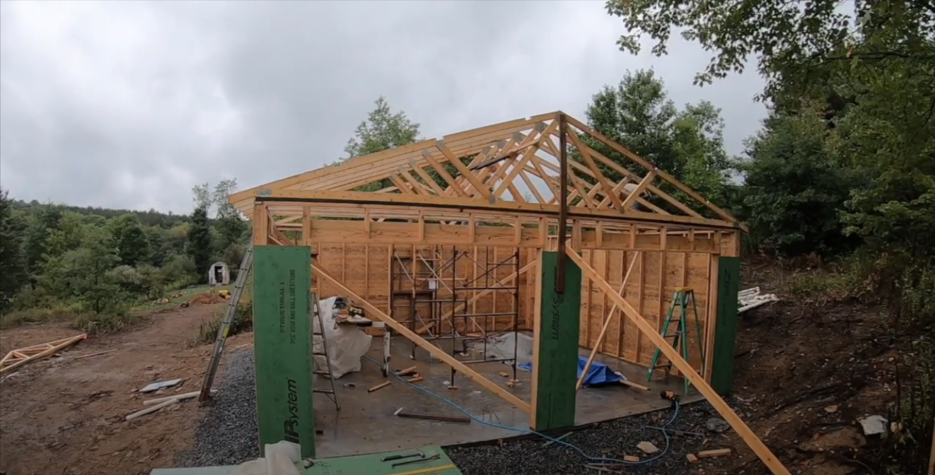 Applying sheathing tape during garage construction