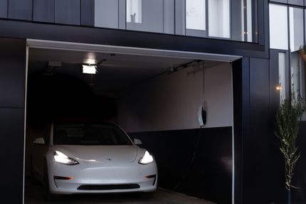 Parked car in newly constructed garage with charging station