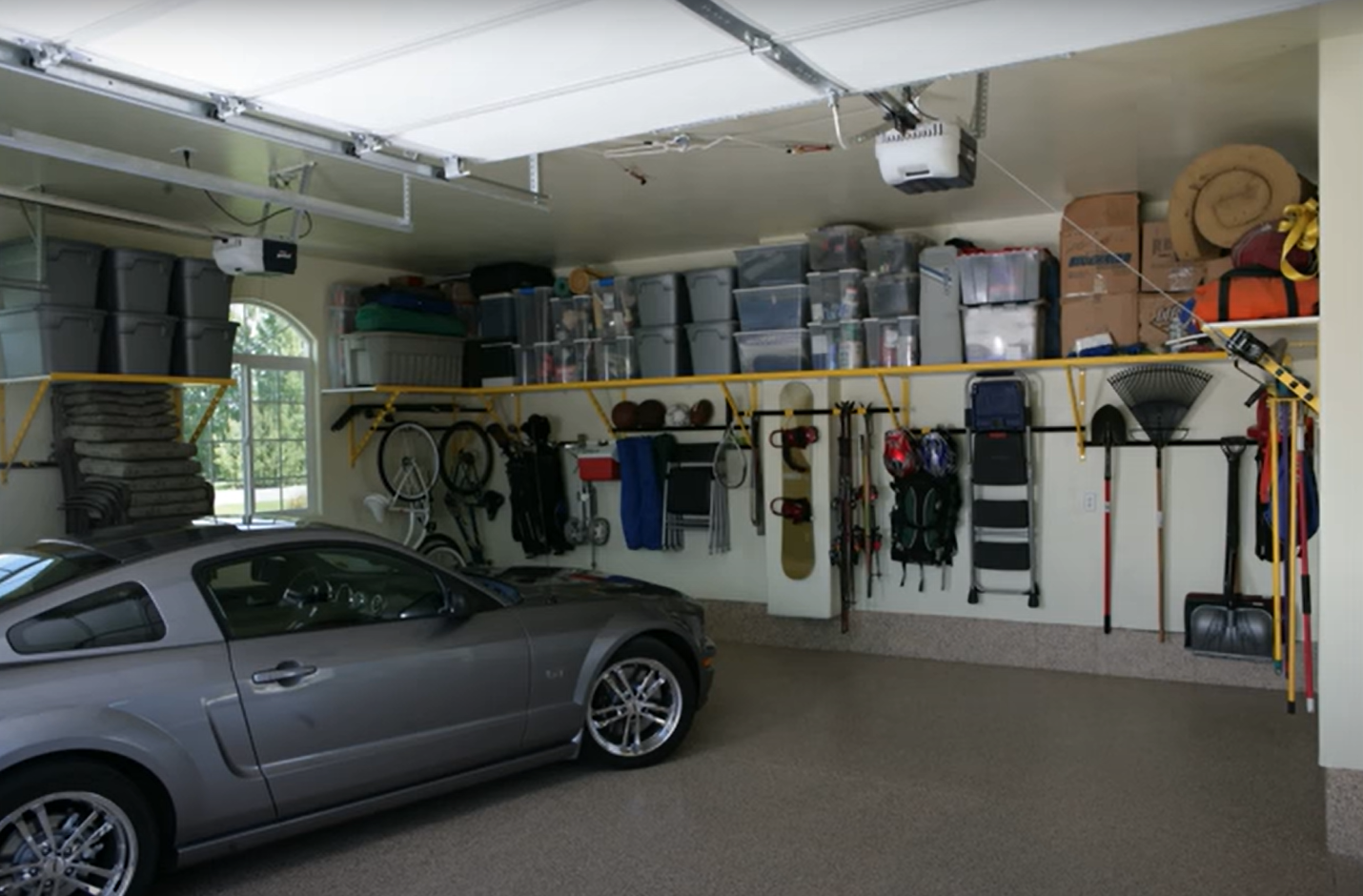 Shelving and wall hangers placed for garage renovation