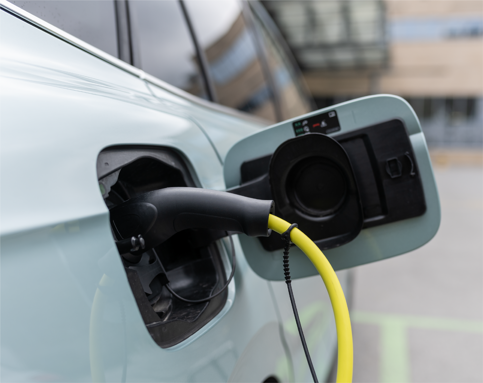 A person is charging an electric car with a charger.