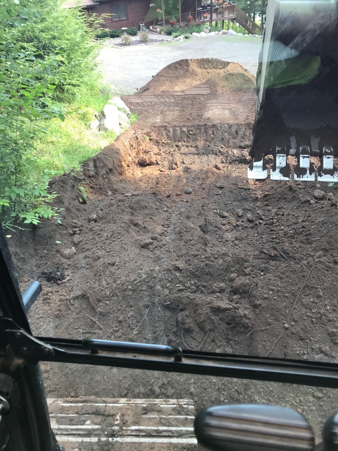 A view of a pile of dirt from inside a bulldozer. A view of a pile of dirt from inside a bulldozer.