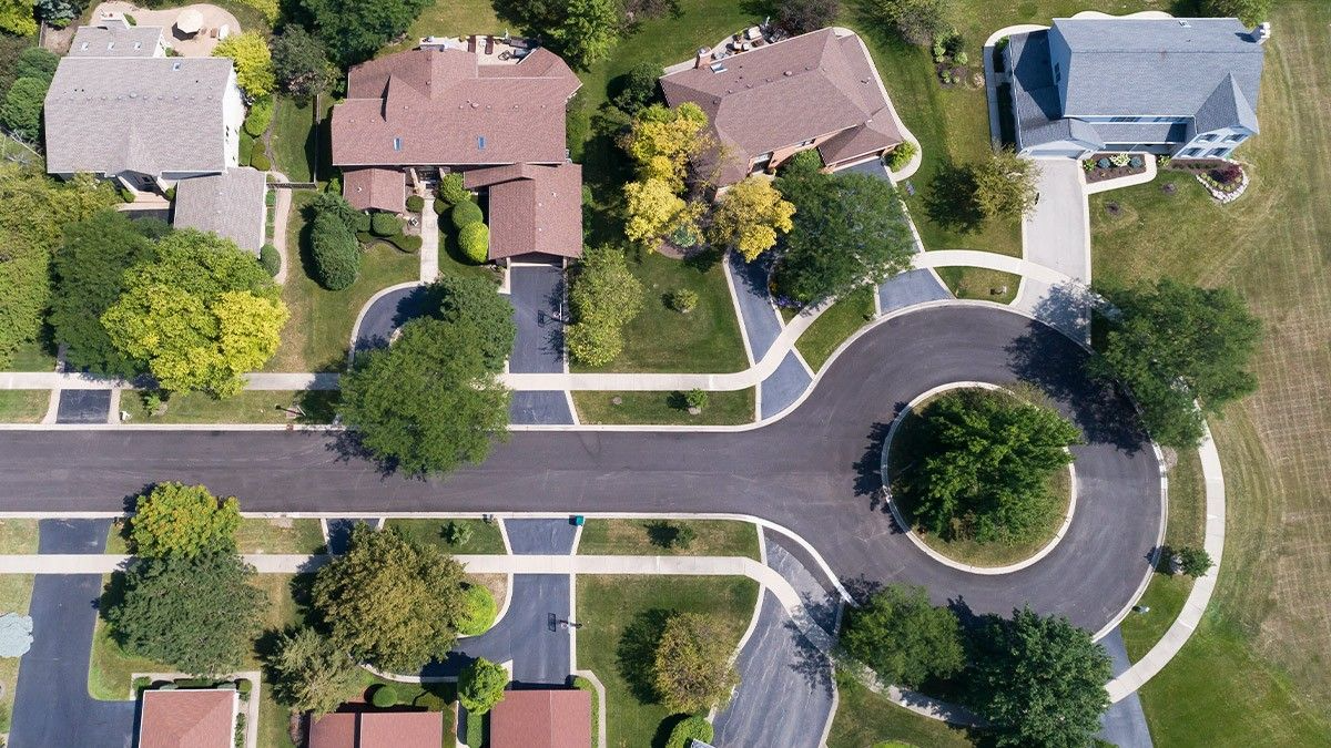 an aerial view of a residential neighborhood with houses and trees .
